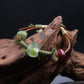 Ancient Liuli Talisman Bracelet, for Grounding & Intention, on a piece of wood against a dark background