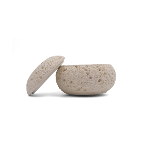 Balance & Clarity Feng Shui Lunar Incense Burner, light-hued round incense holder with porous moon-like texture and partially open lid, spiritual home decor for meditation on a clean white background.