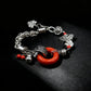 Tibetan Silver bracelet with red charm on a black background
