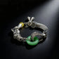 Tibetan Silver bracelet with green gemstones on a black background