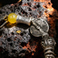 Tibetan Silver bracelet with a yellow bead on a textured dark surface