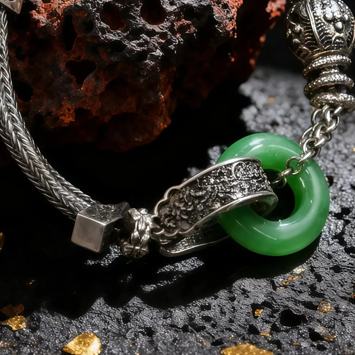 Tibetan Silver bracelet with a green stone on a dark textured surface