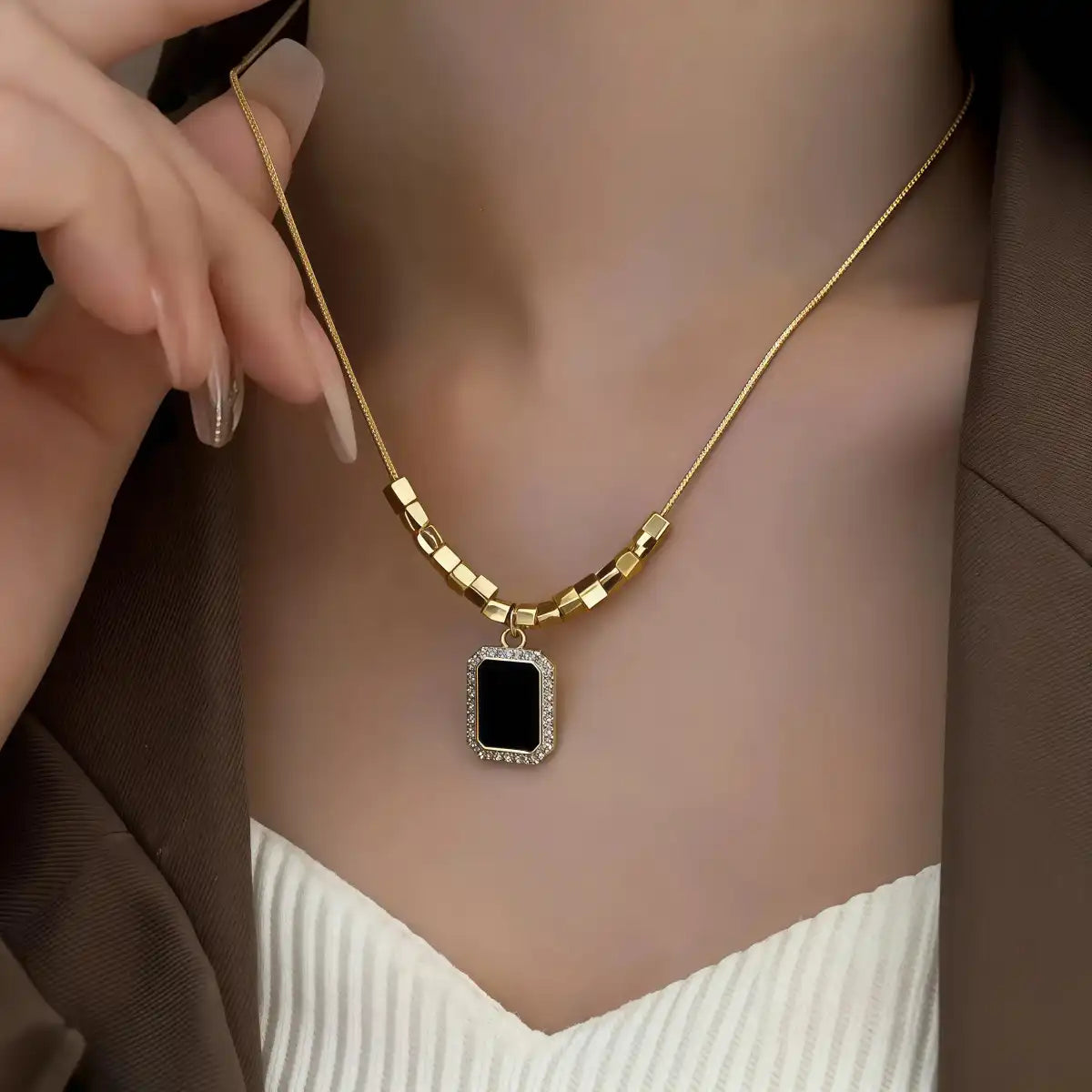 Black CZ halo pendant necklace worn on model, showing fit and style