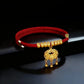 Red pet collar with a gold-tone longevity lock charm displayed on a clean background, showing the simple band and detailed golden lock pendant.