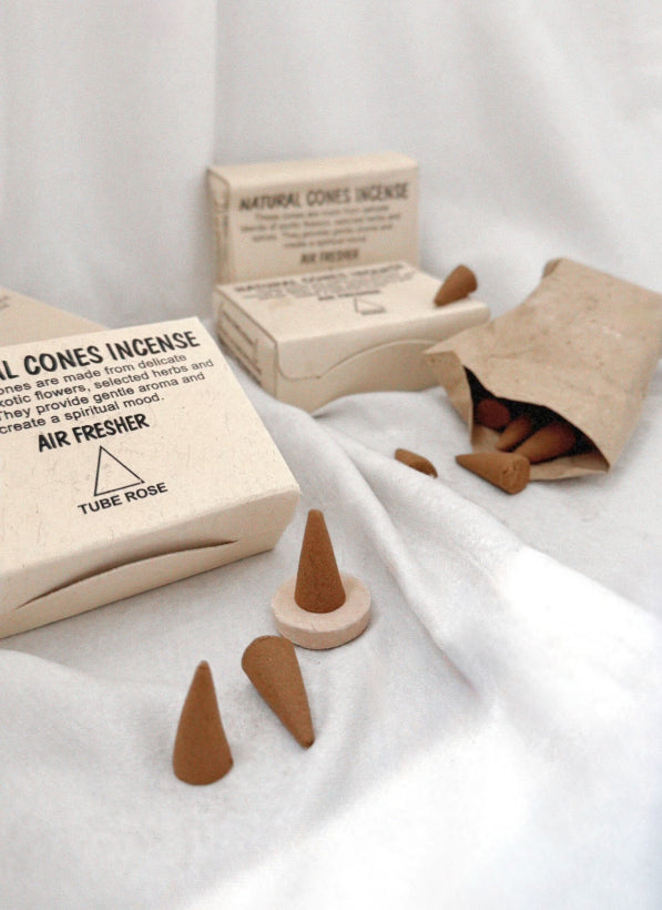 Incense cones and packaging on a white fabric background