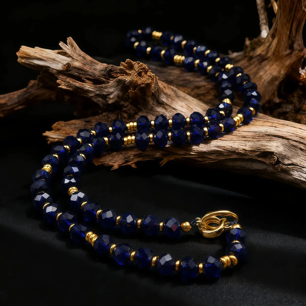 Blue beaded necklace with gold accents on a dark background
