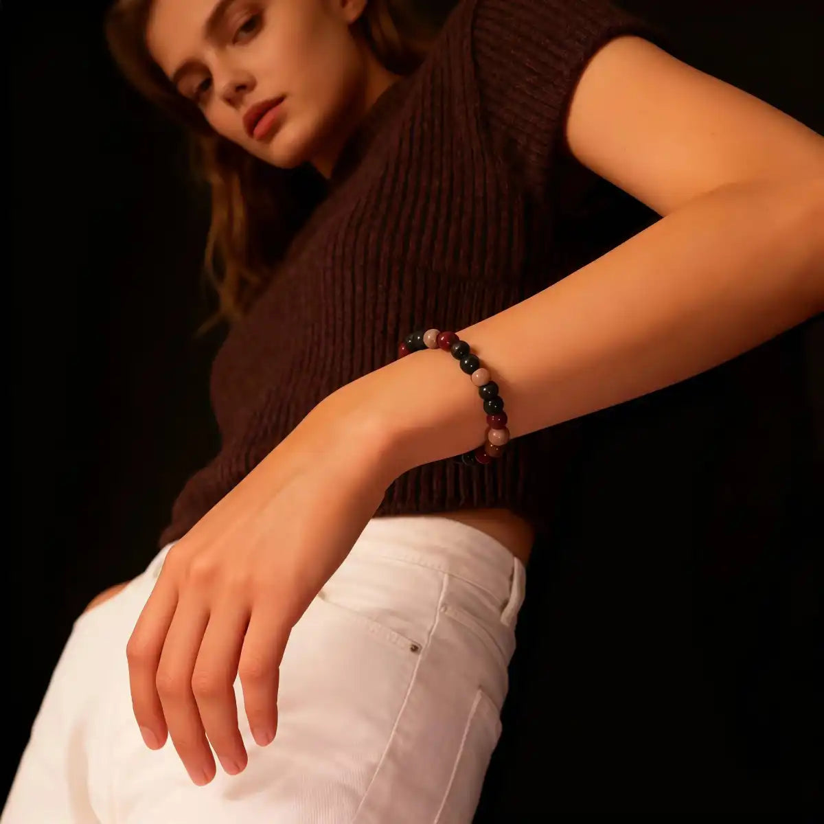 A female model wearing the colorful five-element bead bracelet on her wrist.