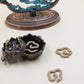 Feng Shui lotus-shaped hanging incense burner with a lotus bowl and cloud-shaped incense coils, set in a decorative frame featuring mountain and cloud details, symbolizing calm and positive energy.