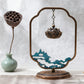 Decorative incense holder with lotus design on a white background