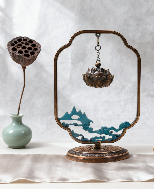 Decorative incense holder with lotus design on a white background
