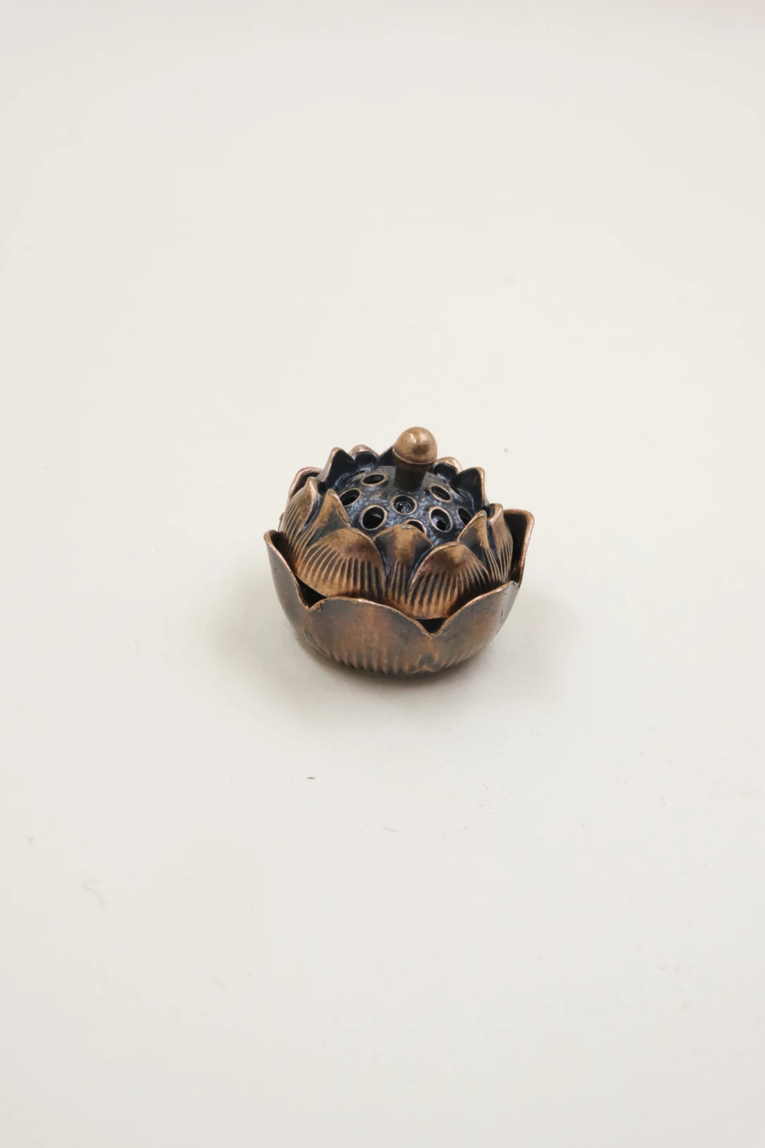 Feng Shui Lotus Incense Burner in bronze finish, featuring a lotus-inspired design with closed lid, used for energy clearing, balance, and inner peace.