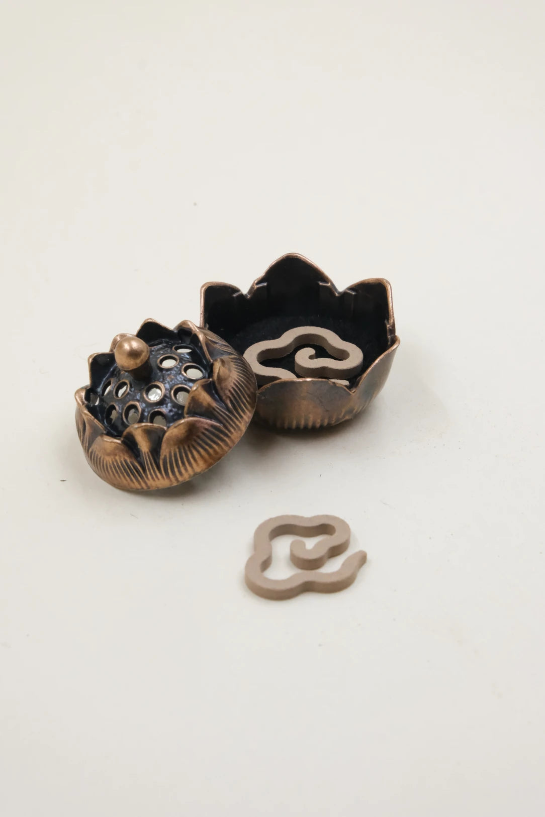 Feng Shui Lotus Incense Burner in bronze lotus design, displayed with open lid and incense chips placed inside, symbolizing energy clearing, balance, and inner peace.