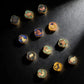 Set of colorful zodiac stone stamps on a dark surface