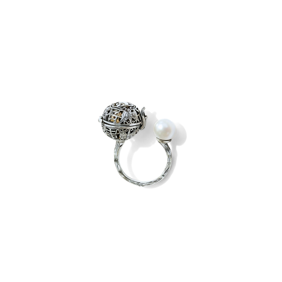 Silver ring with a decorative ball and pearl on a white background
