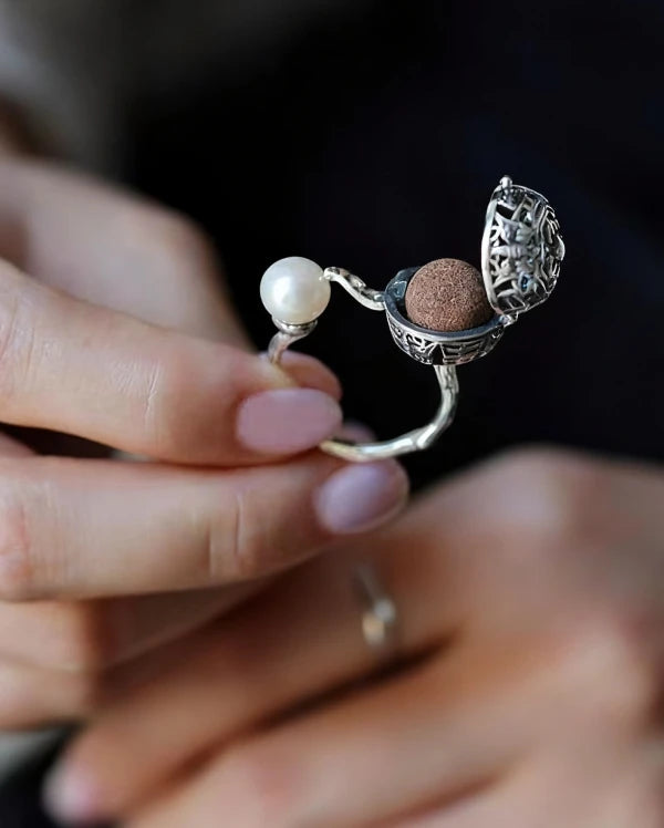 Silver herbal amulet pearl open ring with fragrant locket charm – unique aromatic jewelry combining natural herbs, pearl, and elegant silver craftsmanship.