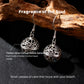 Silver earrings with carved hollow spheres on a dark surface with text describing their features.