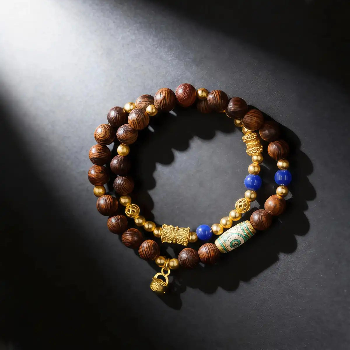Agarwood bracelet with gold-flow accents and Dzi charm, main product view