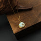 Good luck necklace with a Shoushan Stone pendant on a wooden surface