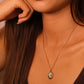 Close-up of a woman wearing Blessings & Clarity Shoushan Stone Good Luck Necklace， with a pendant.