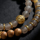 Necklace with gold and natural stone beads on a dark background