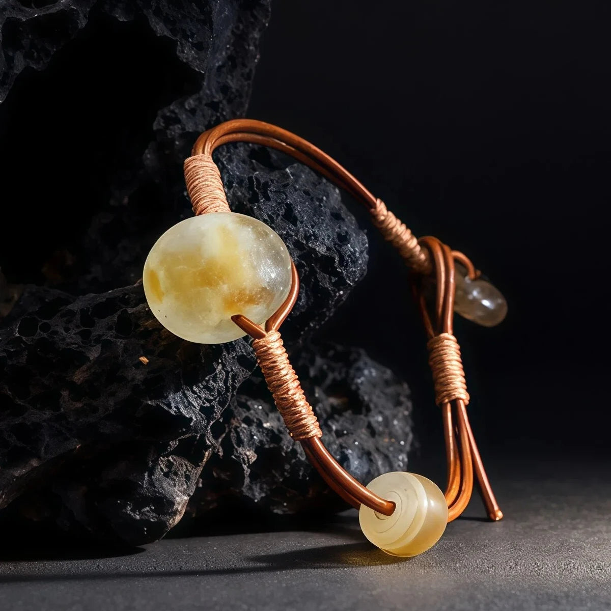 Bracelet with three large beads on a dark background