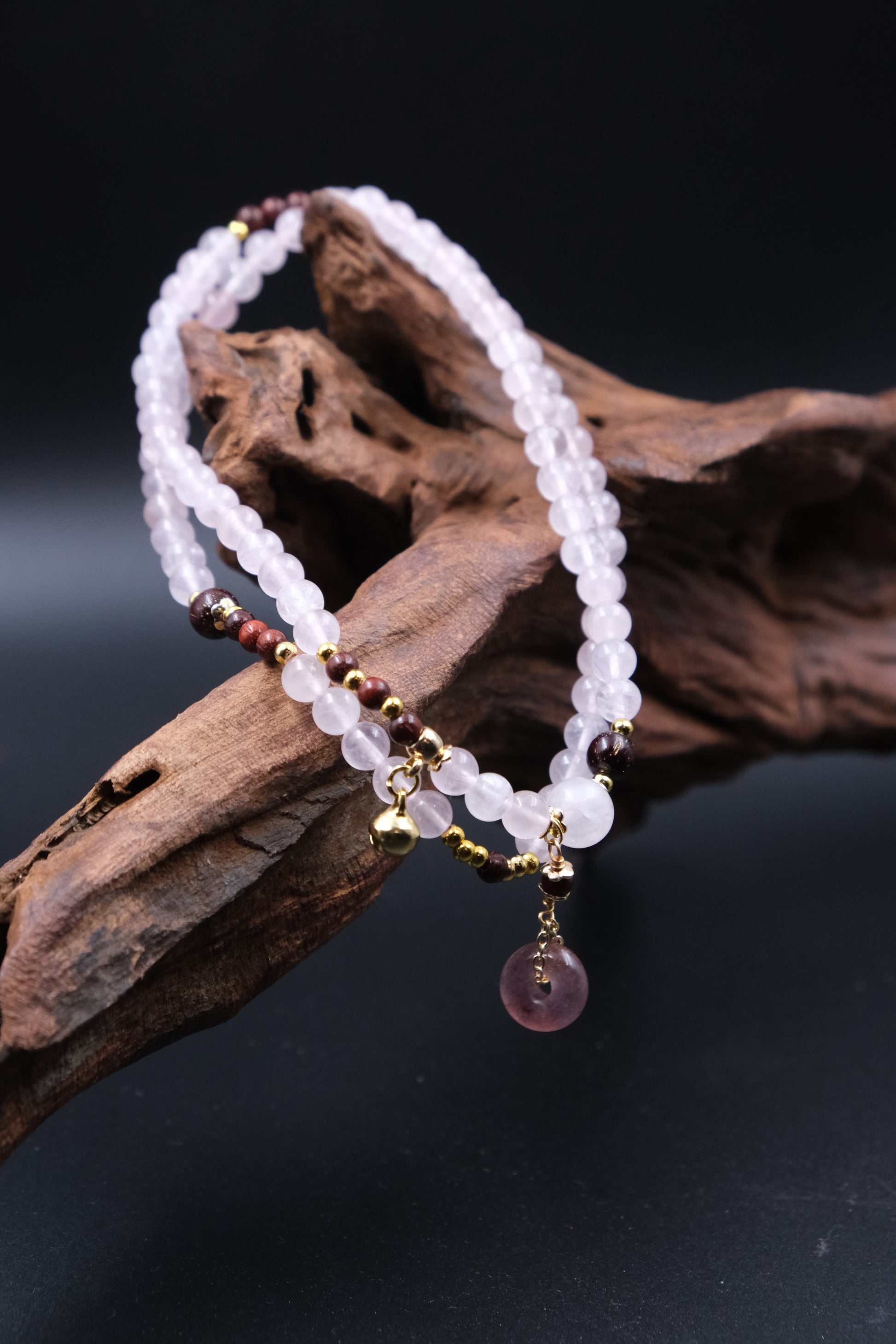 Beaded bracelet with pink crystal/Rose Quartz on a dark background