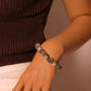 Person wearing a Tibetan Six-Word Mantra Bracelet on a neutral background