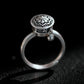 Manifest Flow Tibetan silver Lotus Mantra spinner ring on black background, handcrafted with intricate lotus and mantra design, symbolic energy jewelry for intention and mindfulness.