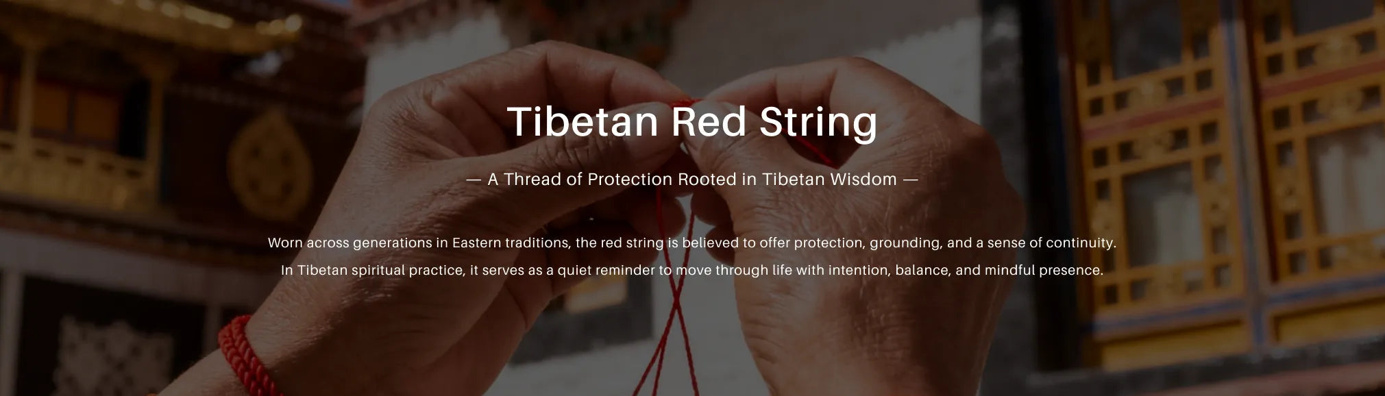 Tibetan Red String with text overlay on a blurred background