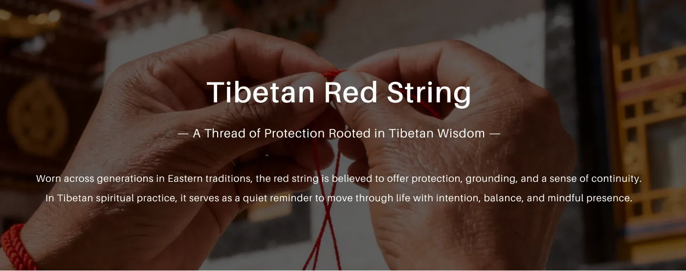 Hand wearing a Tibetan red string bracelet with text about its significance.