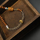 Calm & Positivity – Sandalwood Buddha Charm on a wooden box with a dark background