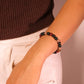 Person wearing a Mindfulness Balance Intention Aromatherapy beaded bracelet on a plain background