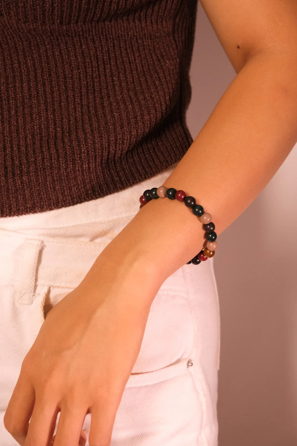 Person wearing a Mindfulness Balance Intention Aromatherapy beaded bracelet on a plain background