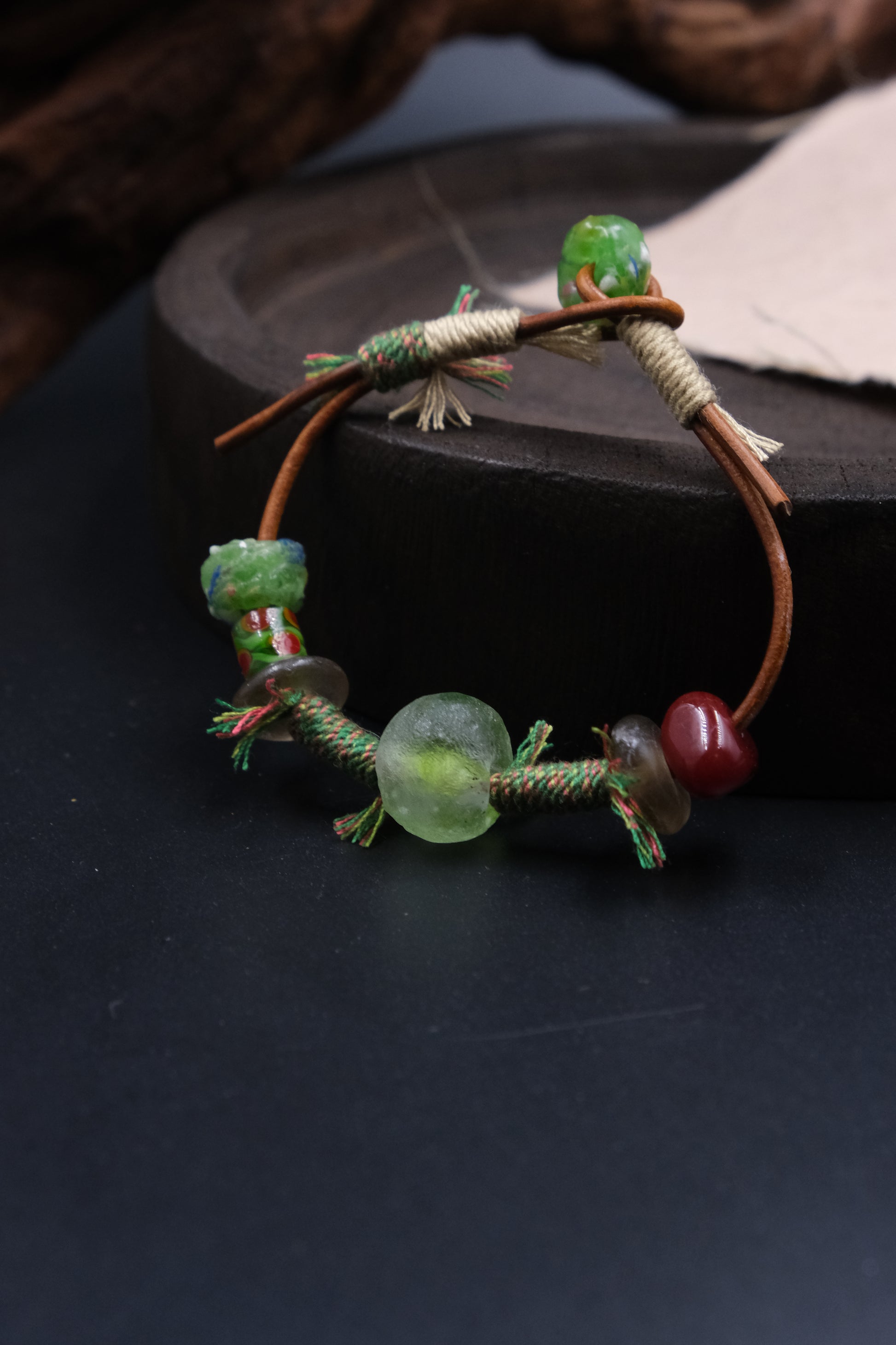 Ancient Liuli Talisman Bracelet for Grounding & Intention on a dark surface