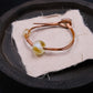 Ancient liuli bead Sun Spirit bracelet, unique design that promotes grounding and inner clarity, styled on a textured background.