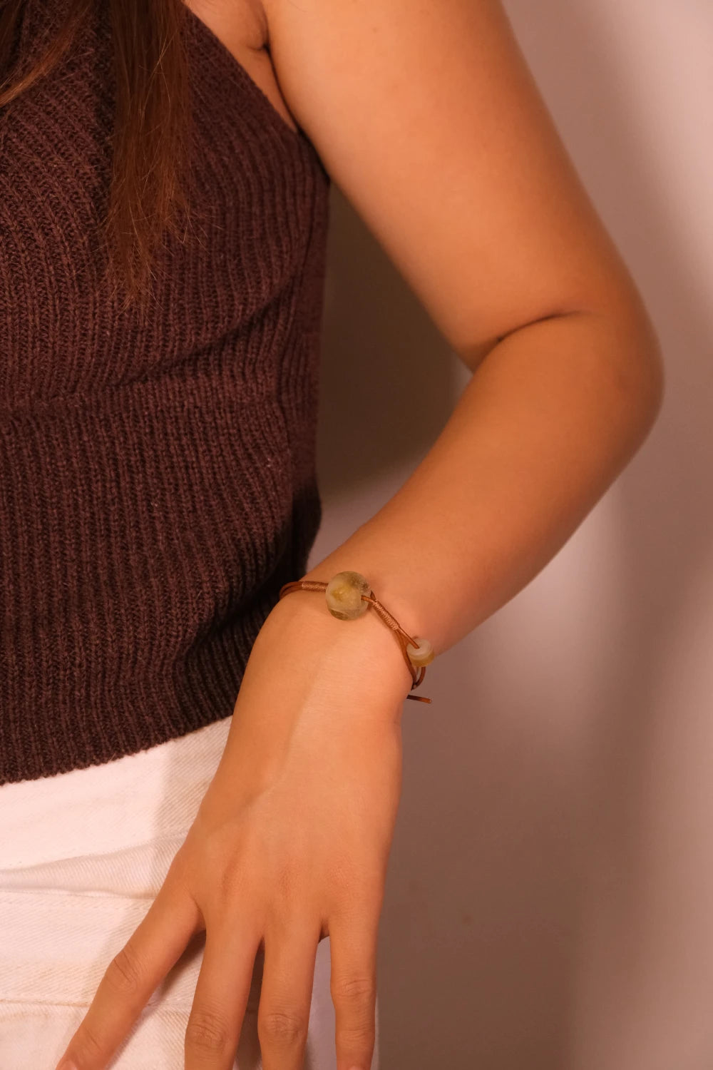 Person wearing a Sun Spirit Bracelet on a plain background, Ancient Liuli for Grounding & Inner Clarity