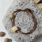Bracelet with natural beads on a stone surface