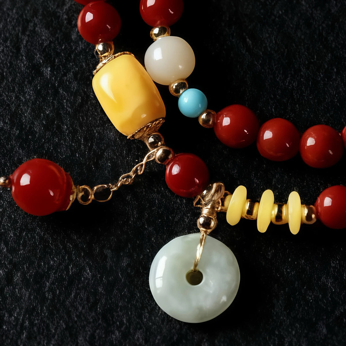 Close-up of beaded bracelet with colorful beads and a gold chain on a dark background
