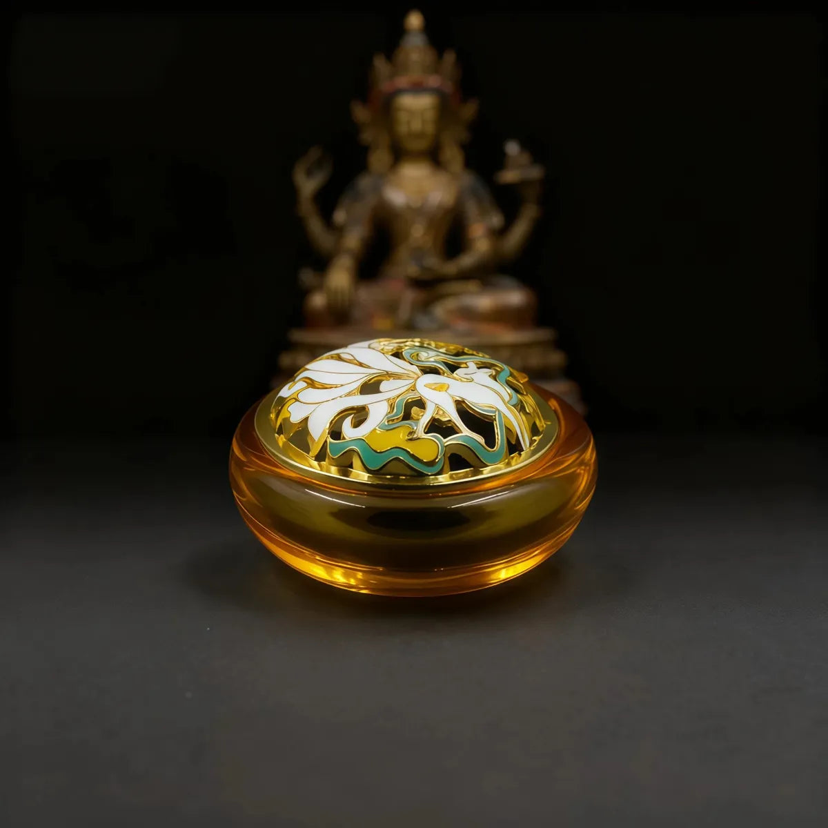 Decorative incense holder with intricate design on a dark background