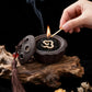 Hand lighting a tibetan incense in a Ceramic Lotus Pod Mini Incense Burner with smoke on a wooden surface.
