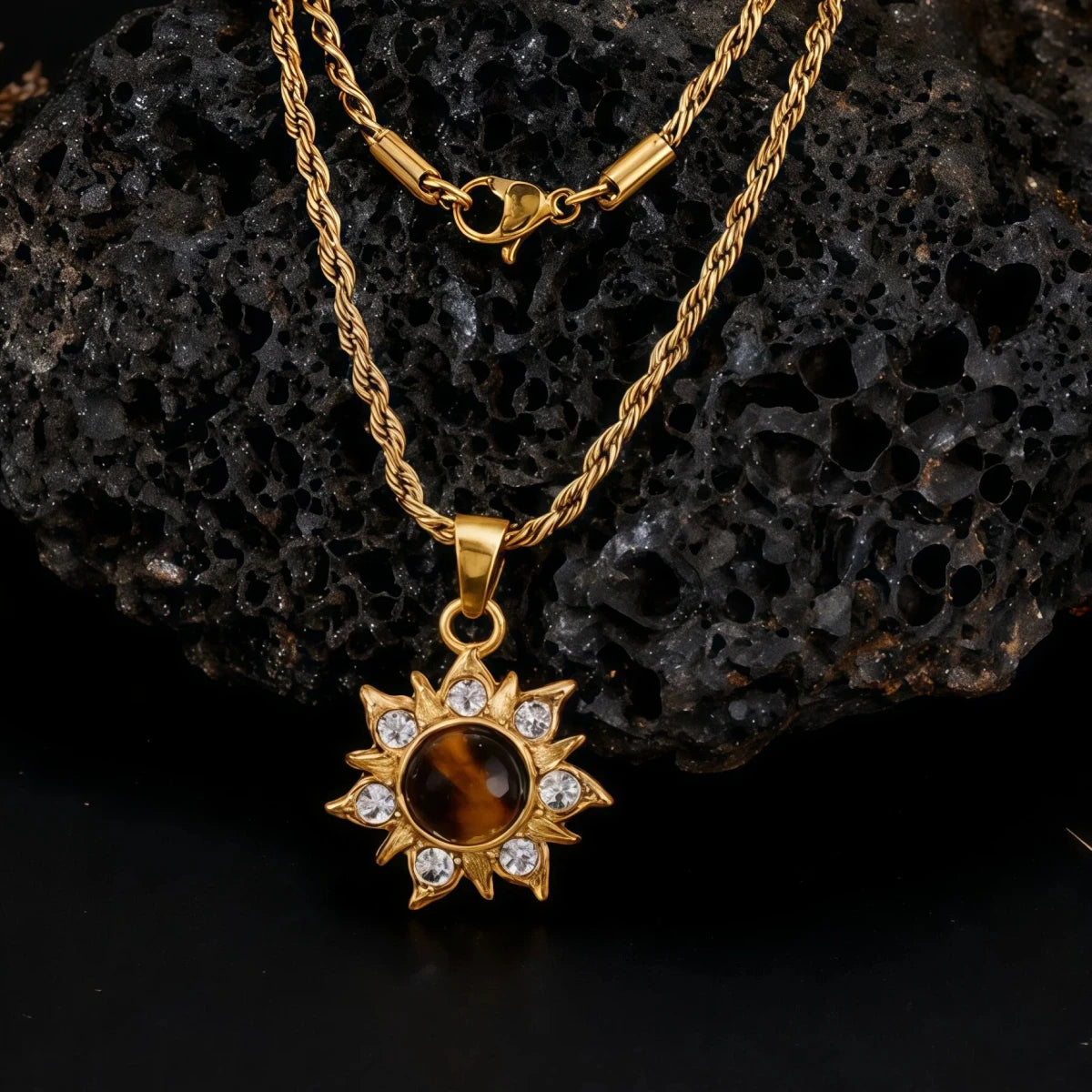 Gold necklace with a sun-shaped pendant on a dark textured background