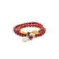 A Tibetan Blessing Bracelet, featuring a double - stranded design. The primary beads are a rich red color, likely red agate. Interspersed among the red beads are smaller yellow, white, and turquoise beads, adding a touch of contrast. A larger white pendant - like bead dangles elegantly from the bracelet, along with a couple of red beads. 