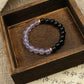 Intuition & Peace – Tibetan Dual Energy Bracelet on a wooden box with a textured fabric background