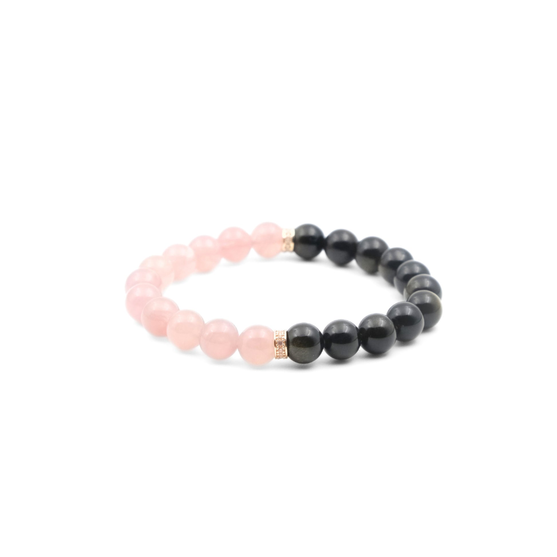 A Tibetan Dual Energy Bracelet showcasing a striking combination of deep - black obsidian beads and soft - pink rose quartz beads. Delicate gold - toned embellishments are placed at the junction of the two types of gemstones. This bracelet is thought to provide protection, attract love, and foster social harmony. 