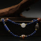 Inspired by Tibetan metaphysical traditions, this Lapis Lazuli Mala / Triple-Wrap Bracelet is a talisman of protection, purification, and healing. Each natural bead is carefully chosen to support spiritual clarity, emotional balance, and overall well-being.
Lapis Lazuli: Connected to the Third Eye chakra, it offers protection, mental clarity, and spiritual insight.
Agate: Grounds and stabilizes energy, shielding against emotional and physical stress.
White Crystal: Clears negative energy and supports energe