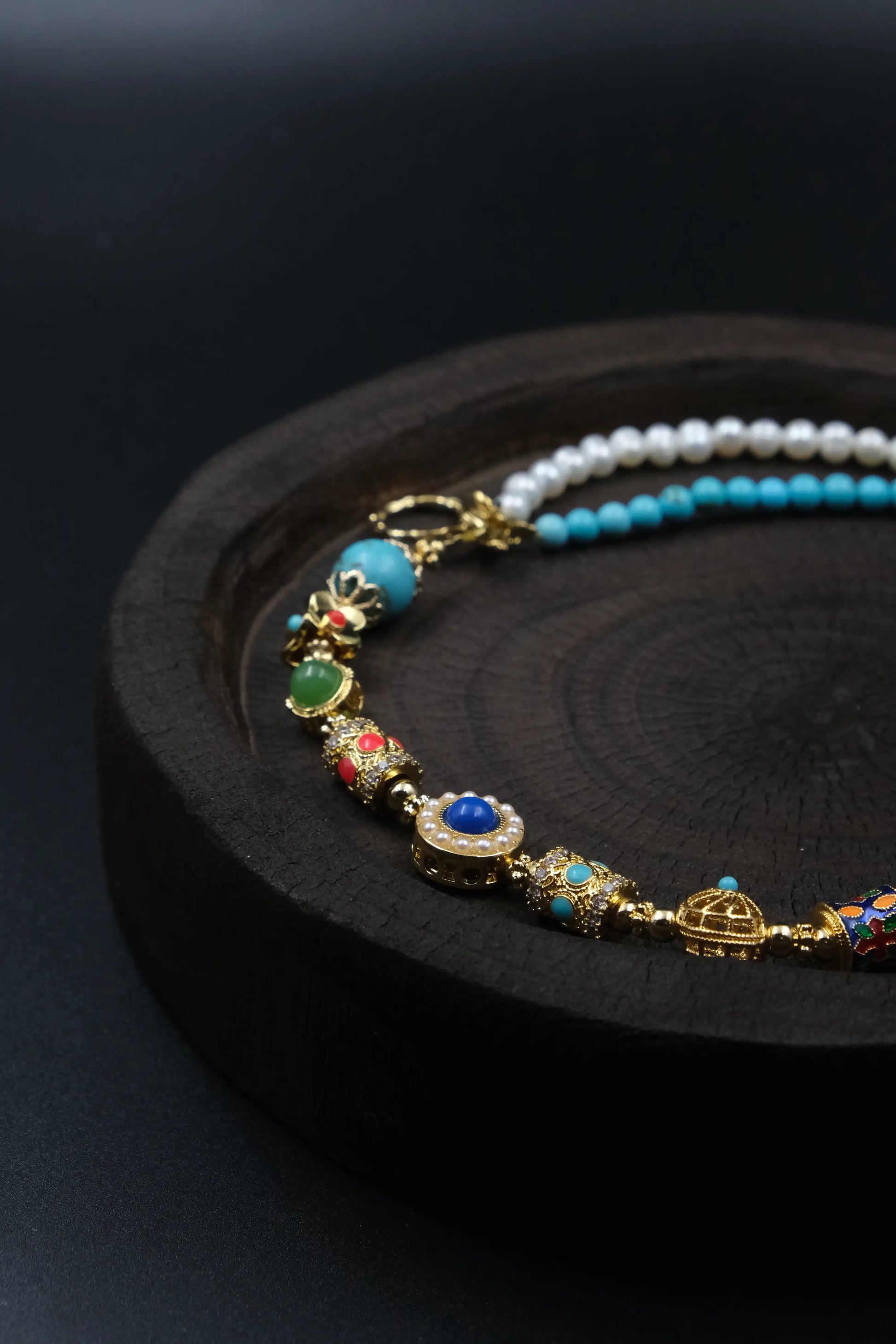 Close - up of Tibetan Energy Healing Bracelet: Featuring pearls, turquoise, and cloisonné elements, designed for emotional balance, protection, and elemental alignment.