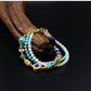 Multicolored Tibetan Energy Healing  beaded bracelet on a wooden surface with a dark background
