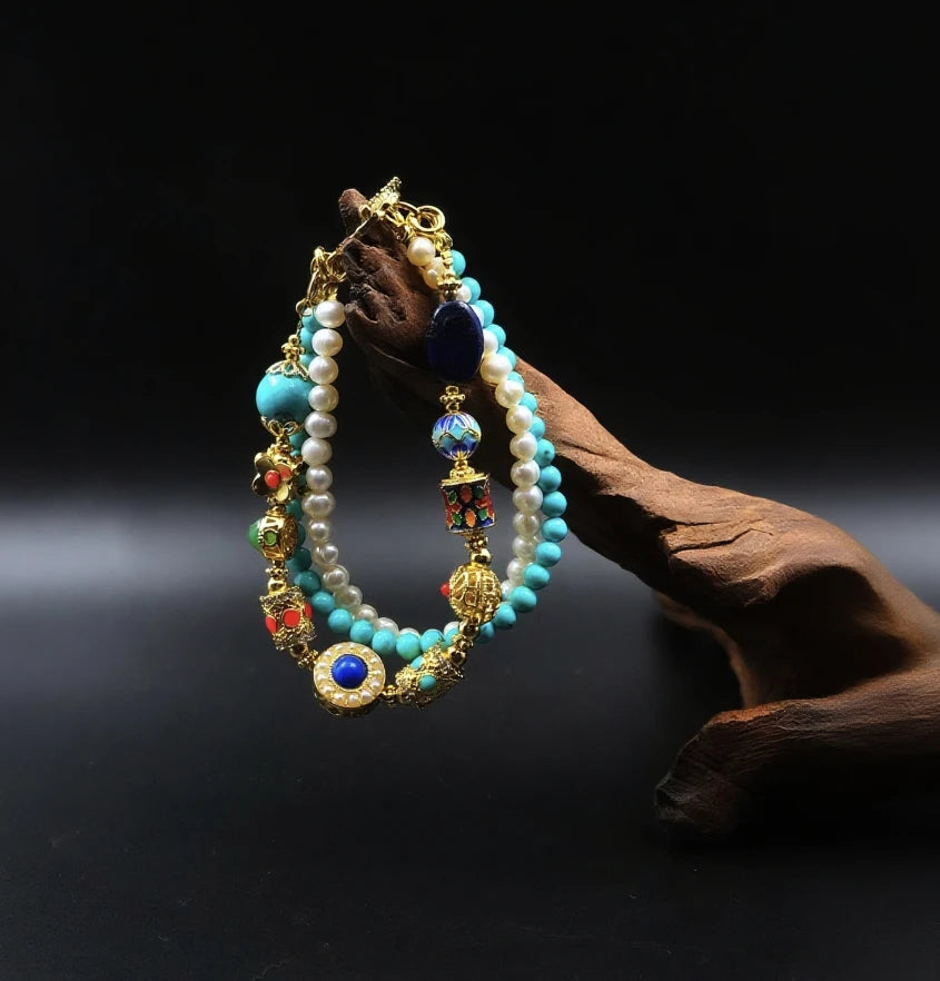 A bracelet featuring multiple strands with elements like pearls, turquoise, and ornate decorative beads . 