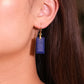 Close-up of a woman wearing a Tibetan Feng Shui Crystal Earrings – Lapis Lazuli for Protection, Purification & Well-Being