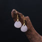 Pair of Tibetan Rose Quartz Earrings with gold hooks on a dark background, for Love, Social Connection & Emotional Healing